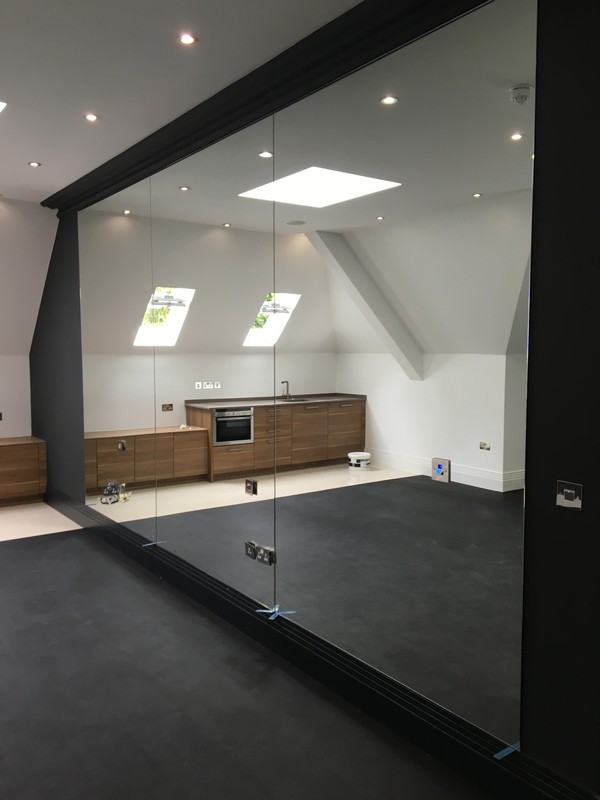 Frameless glass partition in loft conversion by Newport Pagnell glaziers