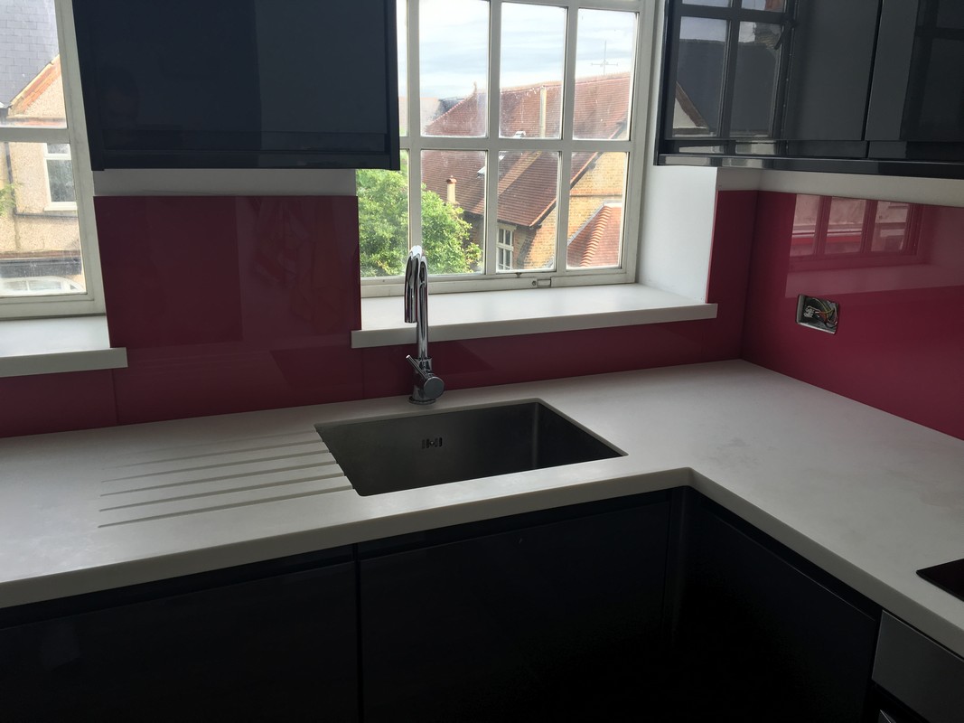 Deep plum coloured glass splashback in modern Newport Pagnell kitchen